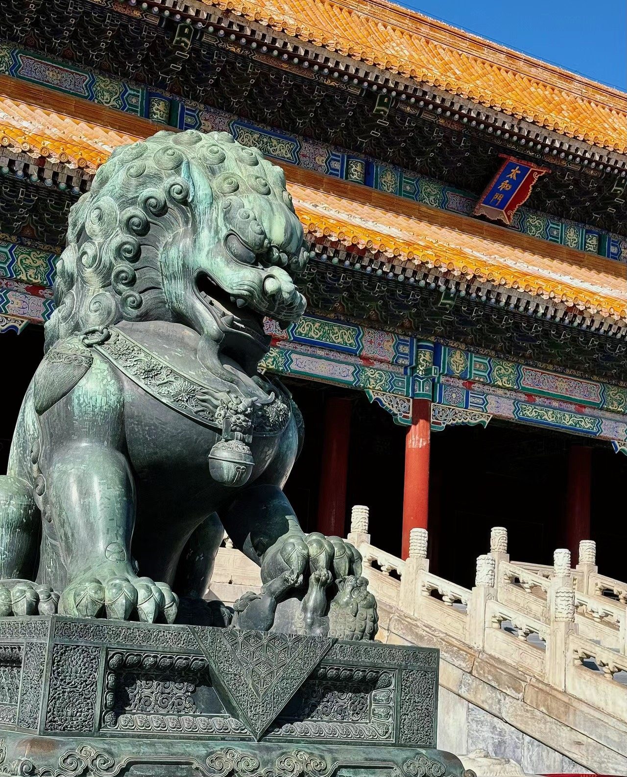 Bronze and stone lion statue symbolizing strength.